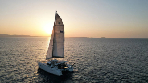 The catamaran silhouetted against the setting sun, capturing the essence of a perfect evening.