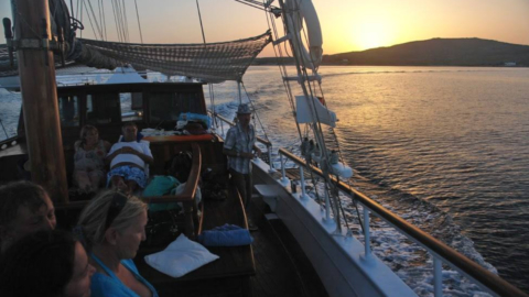 Feel the calm as the boat sails towards the sunset