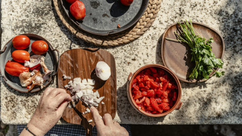 Slicing dry onions for the Greek salad